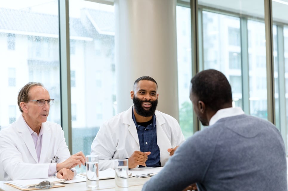 three healthcare professionals meeting